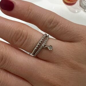 White gold and diamond dangle ring